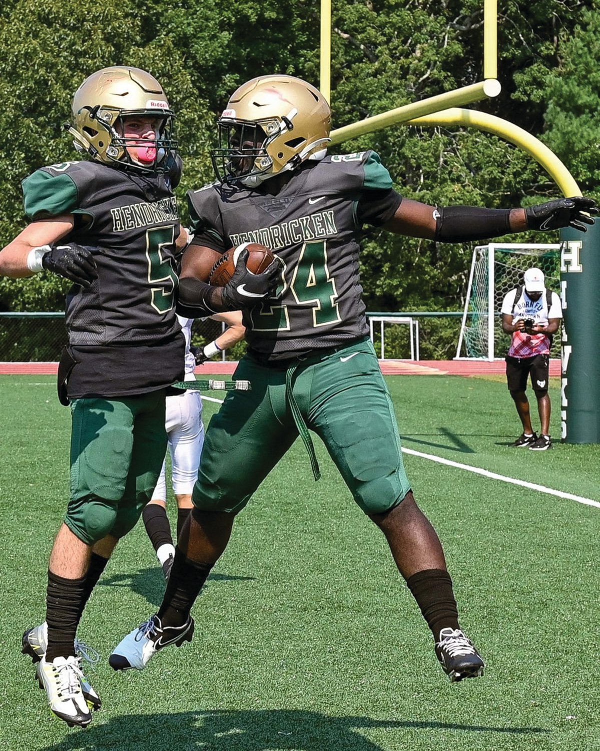 END ZONE: Bishop Hendricken’s Ronjai Francis and Anthony Manna celebrate after scoring a touchdown against Londonderry, New Hampshire at home last weekend. The Hawks kicked off their season by taking on two out-of-state teams and would go 1-1 in the process. Hendricken returned home and is getting ready to face Division I power North Kingstown this weekend for its first league contest of the fall season. (Photos by Leo van Dijk/rhodyphoto.zenfolio.com)